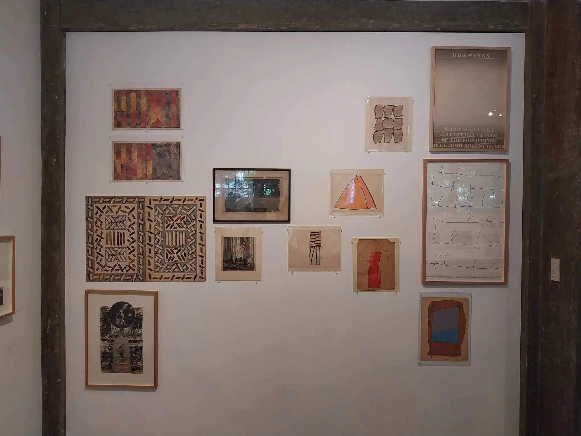 Wall of posters and sample art works for "Early Philippine Contemporary Art" at Calle Wright.
