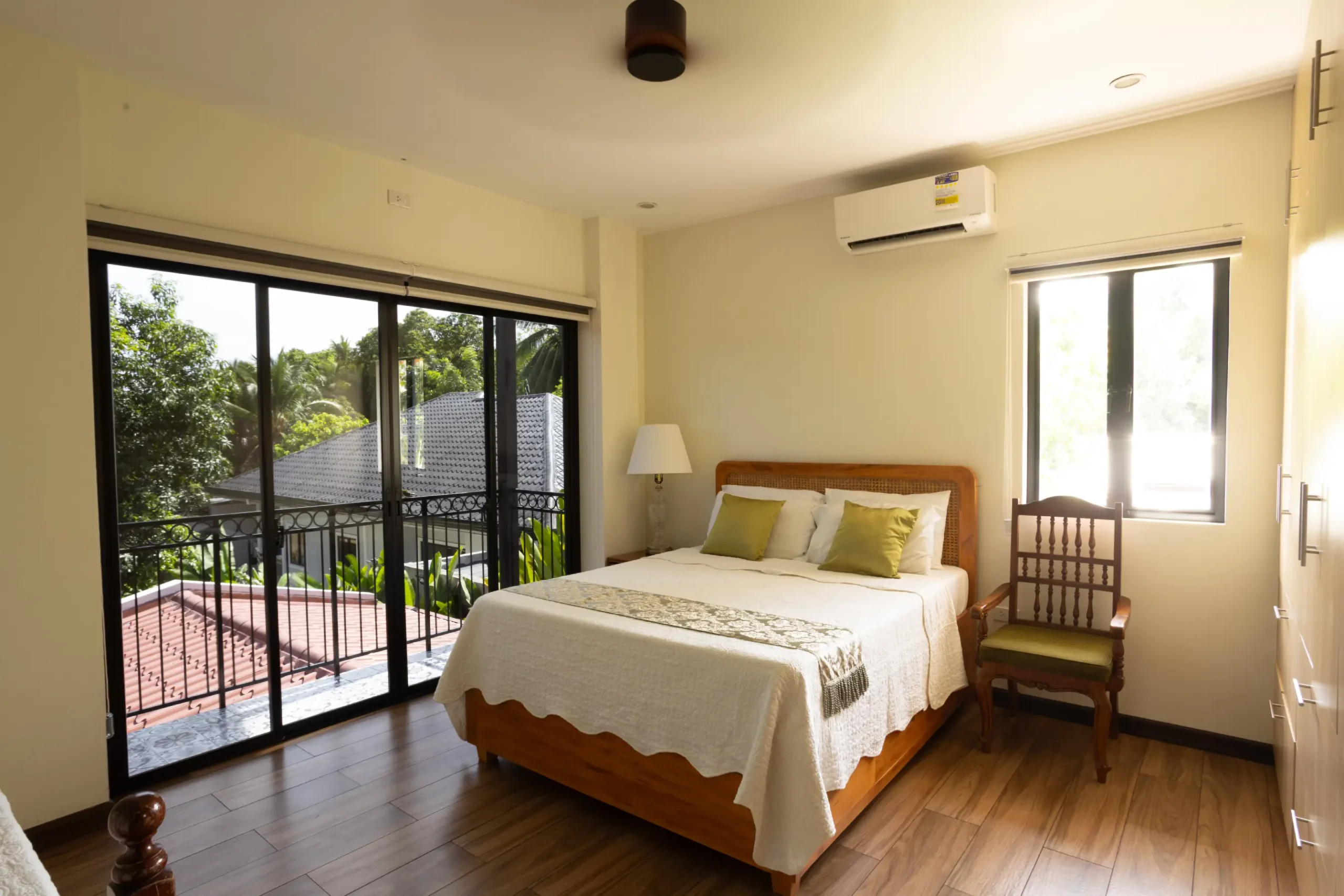 Glass sliding doors that open to a balcony give one of the bedrooms a view of the outdoors and allow generous amounts of natural light to pour in.