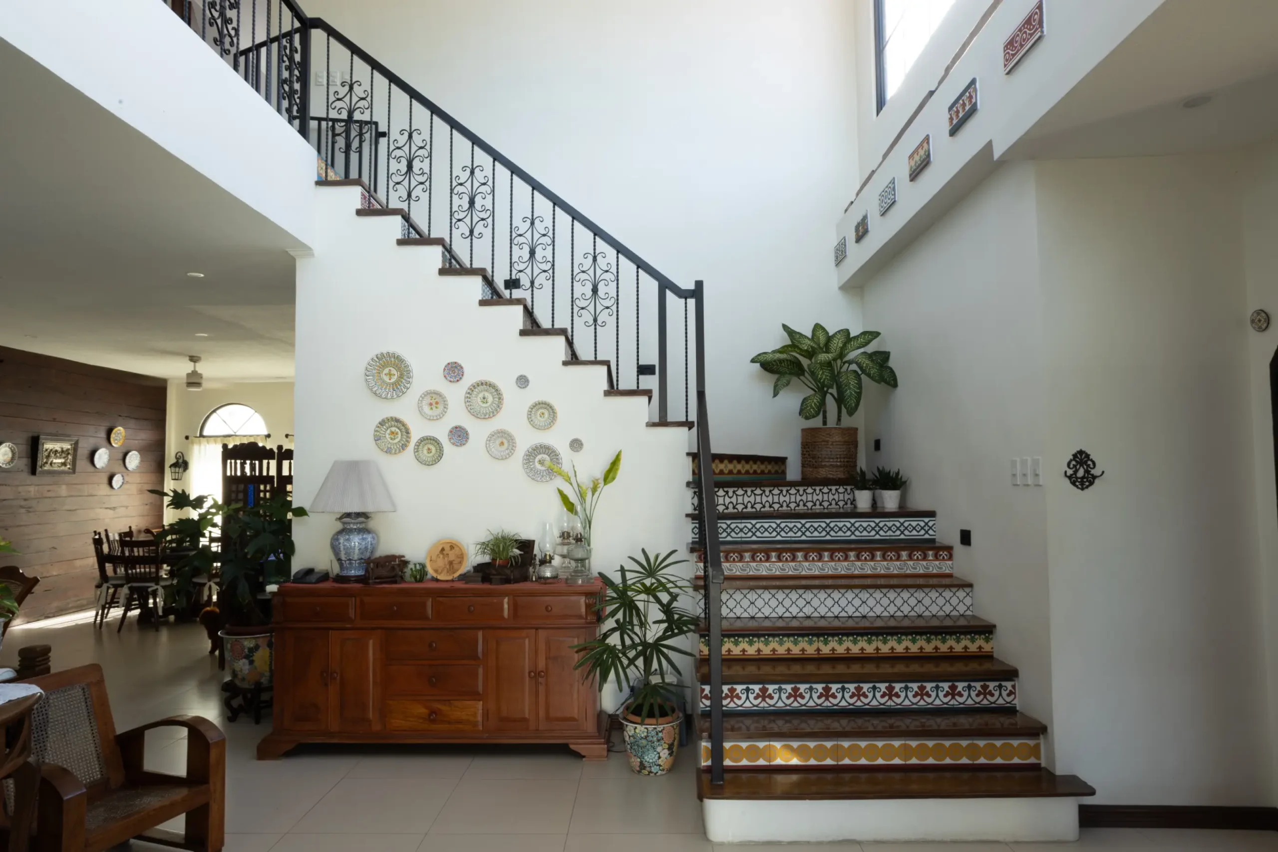 More Machuca tiles appear at the foyer, where patterned flooring defines the space and creates a striking first impression. On the stair risers, the same tiles add character and visual interest to the transitional zone.
