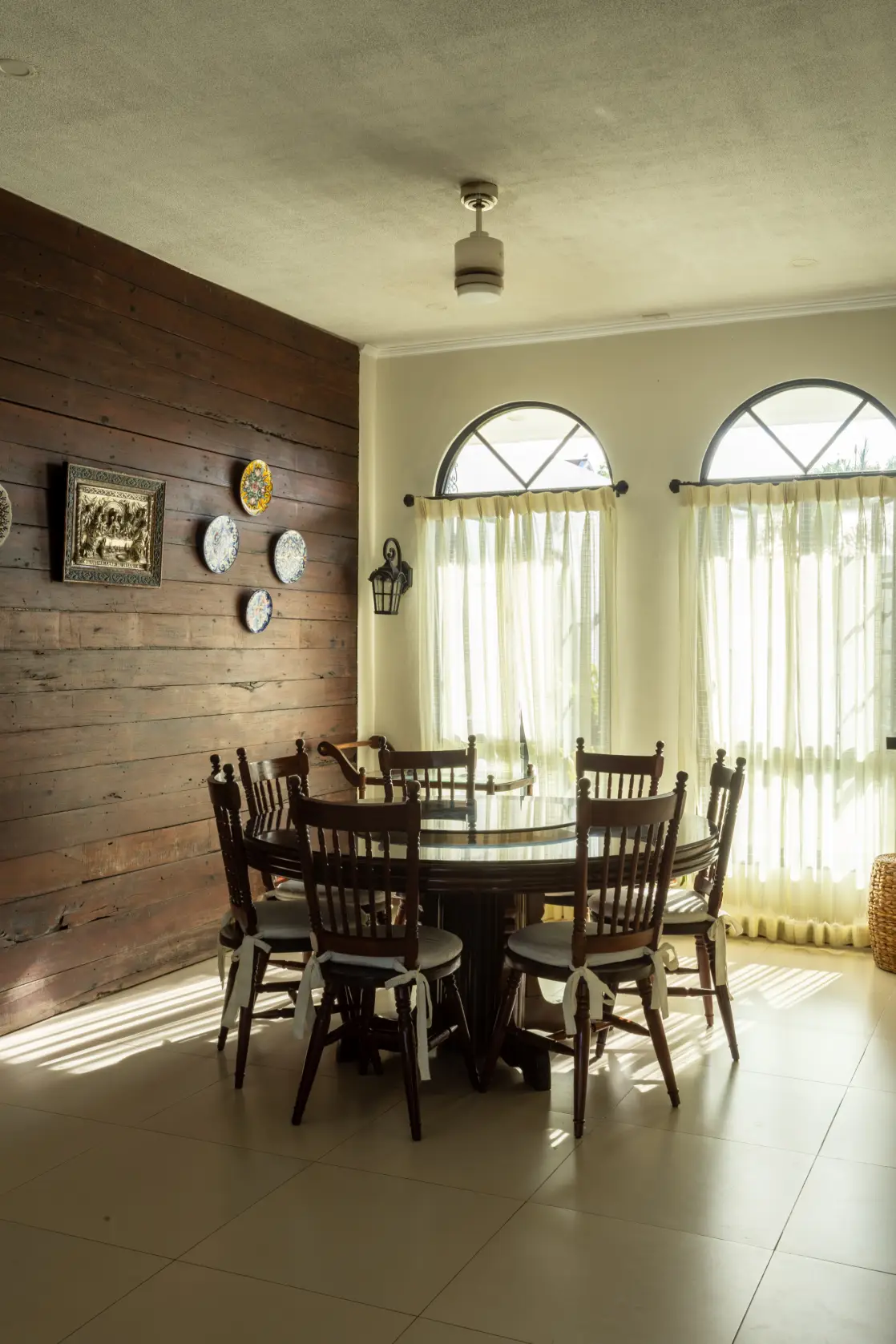 The reclaimed wood accent wall anchors the dining area while adding warmth and texture to the space.