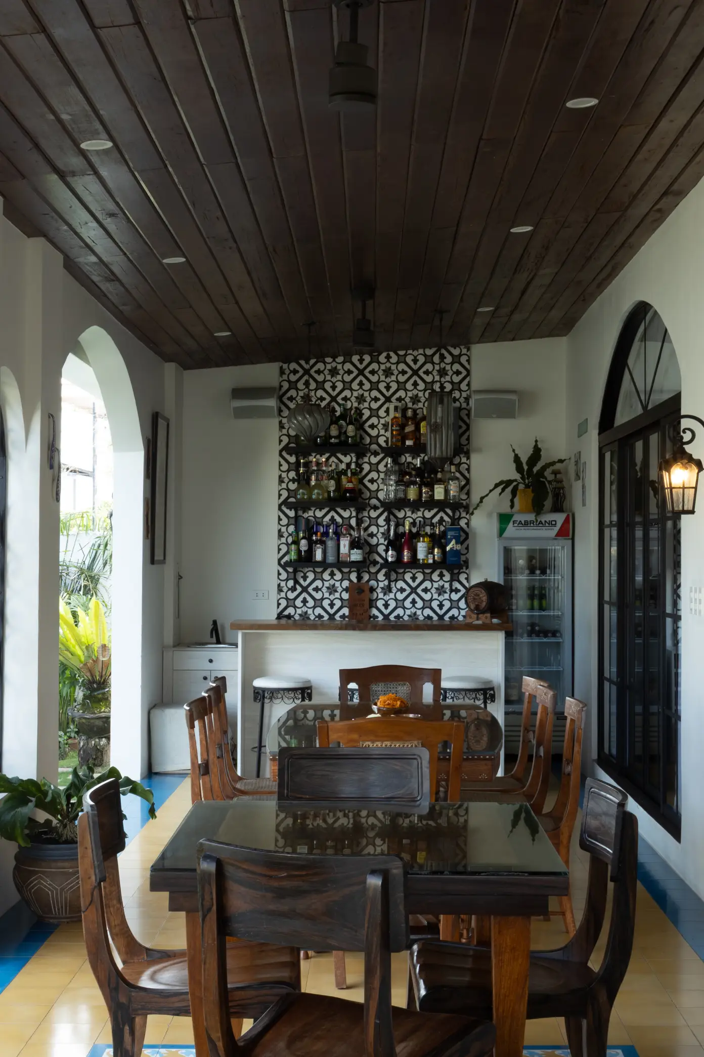 The lanai functions as the home’s main gathering space, seamlessly linking indoor and outdoor areas and anchored by a custom-made bar for entertaining.