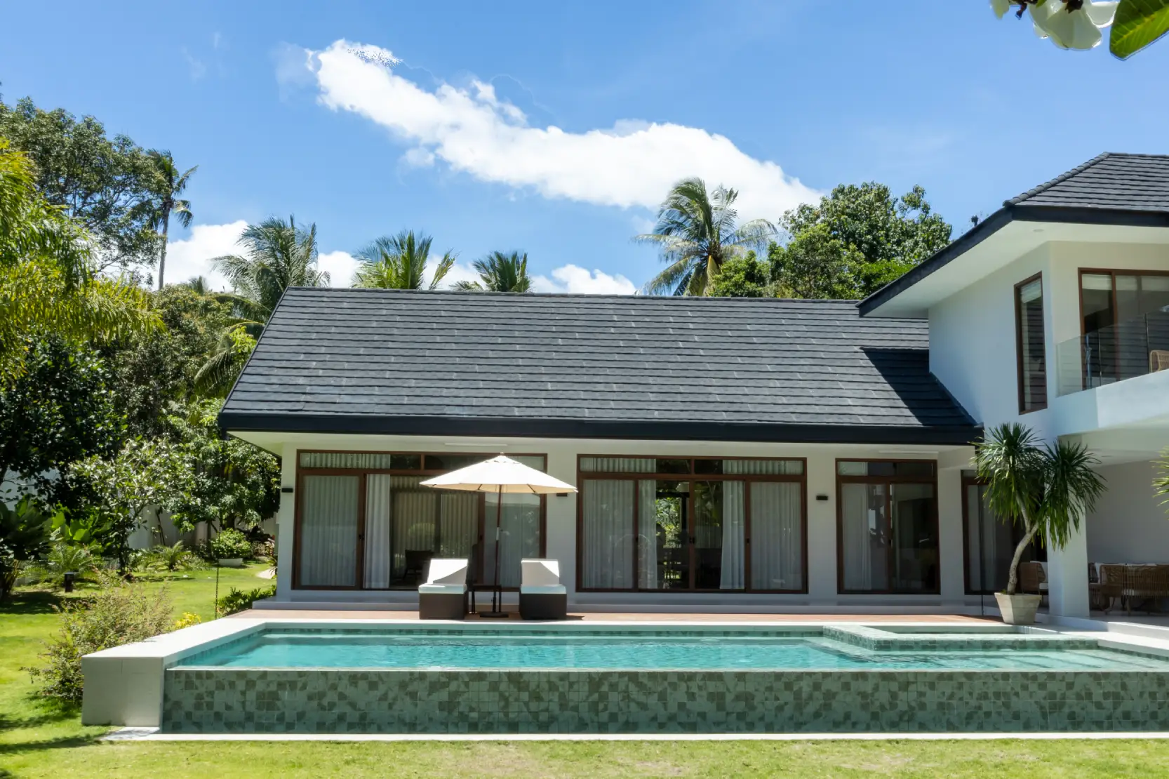 Sukabumi tiles line the pool at Villa Tropicana, hiding grout lines and creating a seamless, natural look.