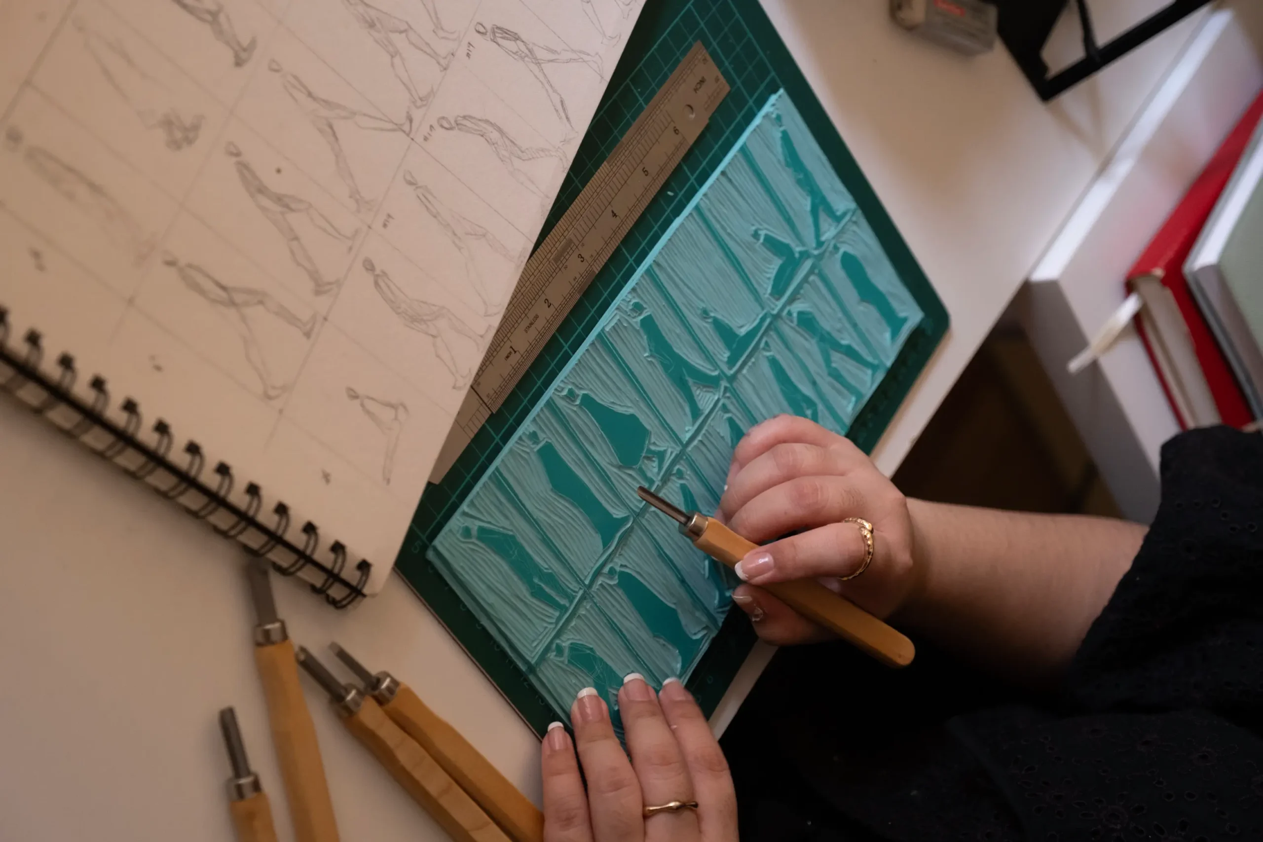 The artist working on the references of her figurines for her works.