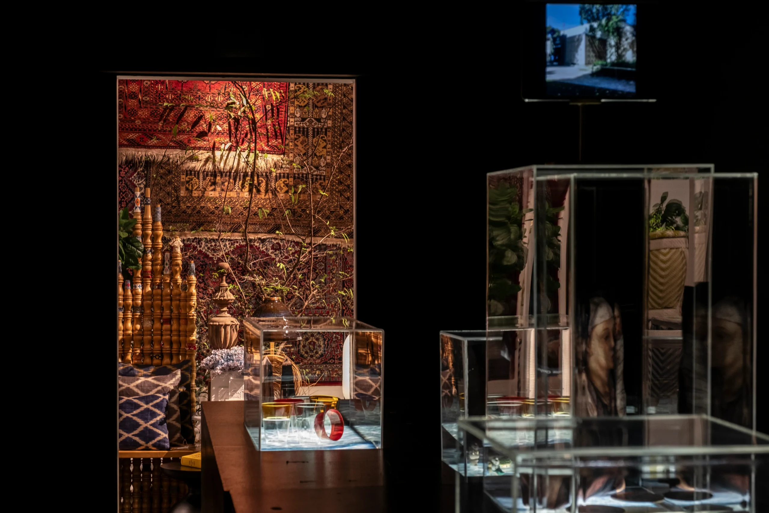 Black anteroom inside Ito Kish’s Makati showroom featuring textiles and glass display cases.