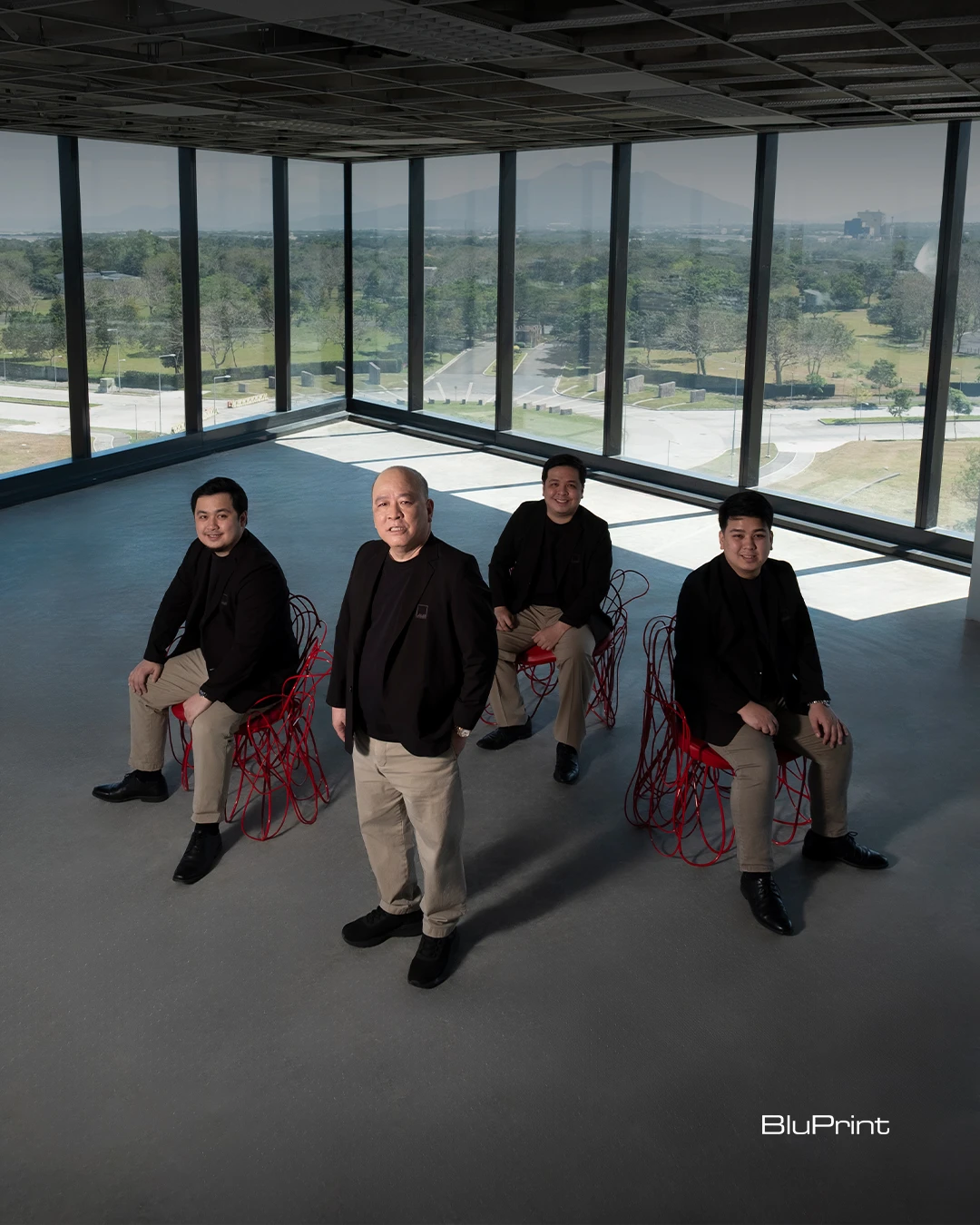 Jose Siao Ling and his sons of JSLA Architects inside the LHK Building in Nuvali, framed by floor-to-ceiling glass windows.